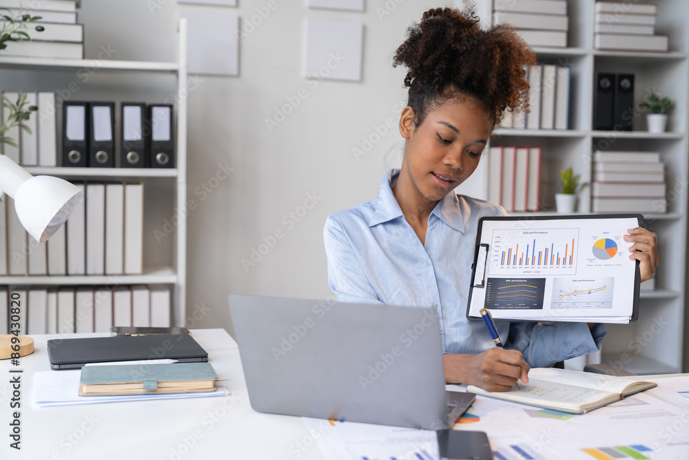 happy young businesswoman African American siting on the chiar cheerful demeanor raise holding coffee cup smiling looking laptop screen.Making opportunities female working successful in the office. happy young businesswoman African American siting on the chiar cheerful demeanor raise holding coffee cup smiling looking laptop screen.Making opportunities female working successful in the office.