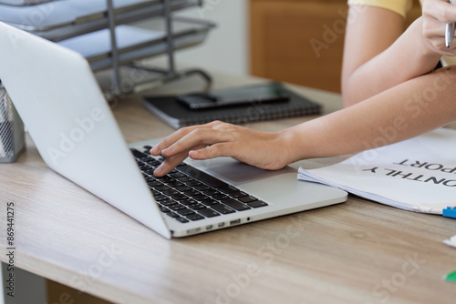 Woman Paying Bills Online Using Laptop at Home Office Desk with Documents and Calculator