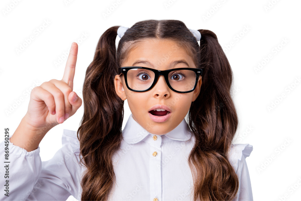Close-up portrait of nice cute minded funny adorable lovely stylish small little girl with curly pigtails in white formal blouse shirt, wearing glasses, pointing up. Isolated over grey background Close-up portrait of nice cute minded funny adorable lovely stylish small little girl with curly pigtails in white formal blouse shirt, wearing glasses, pointing up. Isolated over grey background