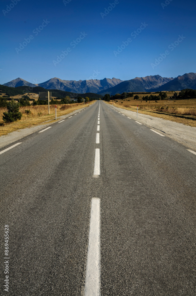 Straight road from La Quillane to Les Angles (France). At the background, some mountains from Pyrenees Orientales Straight road from La Quillane to Les Angles (France). At the background, some mountains from Pyrenees Orientales