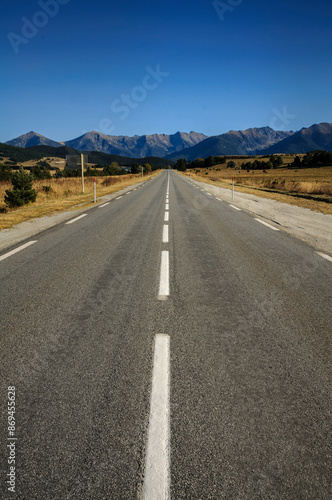 Straight road from La Quillane to Les Angles (France). At the background, some mountains from Pyrenees Orientales