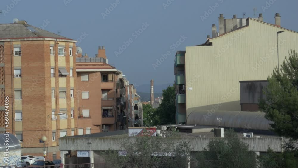 Old chimney or tower from a defunct textile factory among the buildings in Terrassa Old chimney or tower from a defunct textile factory among the buildings in Terrassa