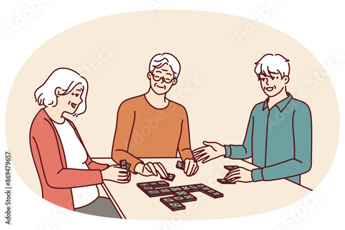 Elderly people play dominoes undergoing rehab at nursing home or having sunday get-together with friends. Men and women are sitting at table enjoying game of dominoes with former colleagues