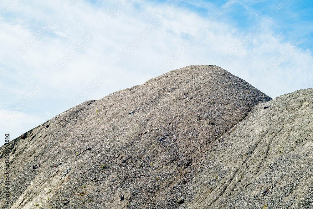 A large pile of rubble for road construction. Crushed stone for concrete mix. large piles of crushed granite or gravel in the concrete industry. A large pile of rubble for road construction. Crushed stone for concrete mix. large piles of crushed granite or gravel in the concrete industry.