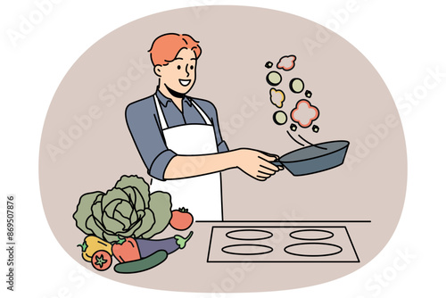 Man cook stands at stove and prepares romantic dinner of fried vegetables for beloved woman. Chef cook guy throws food on pan demonstrating skills of professional culinary specialist