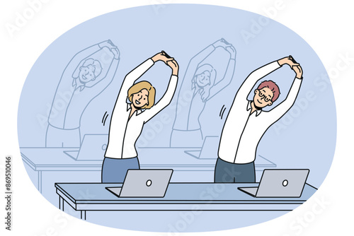 Office workers do exercises standing at workplaces and stretching arms up. Business men and women doing office fitness to increase work productivity or fight diseases associated with sedentary work