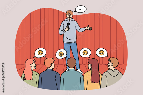 Man stand-up comedian performs in front of audience, telling jokes from stage and making people laugh. Guy works as comedian and cheers up men or women who attended comedy concert.