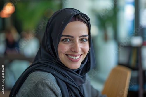 Smiling Middle eastern businesswoman wearing a hijab having a meeting conversation with a co-worker at the workplace, Generative AI