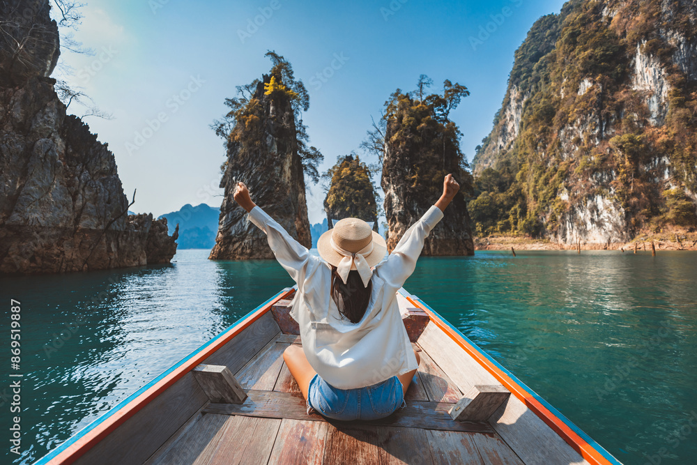Traveler asian woman relax and travel on Thai longtail boat in Ratchaprapha Dam at Khao Sok National Park Surat Thani Thailand Traveler asian woman relax and travel on Thai longtail boat in Ratchaprapha Dam at Khao Sok National Park Surat Thani Thailand