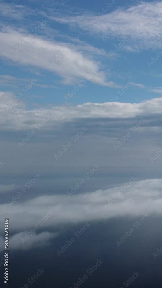 Aerial view. Blue sky sun and fog over calm sea. The drone flies over foggy and fluffy clouds. Abstract aerial nature summer ocean sunset sea and sky background. Vacation, travel and holiday concept. Aerial view. Blue sky sun and fog over calm sea. The drone flies over foggy and fluffy clouds. Abstract aerial nature summer ocean sunset sea and sky background. Vacation, travel and holiday concept.