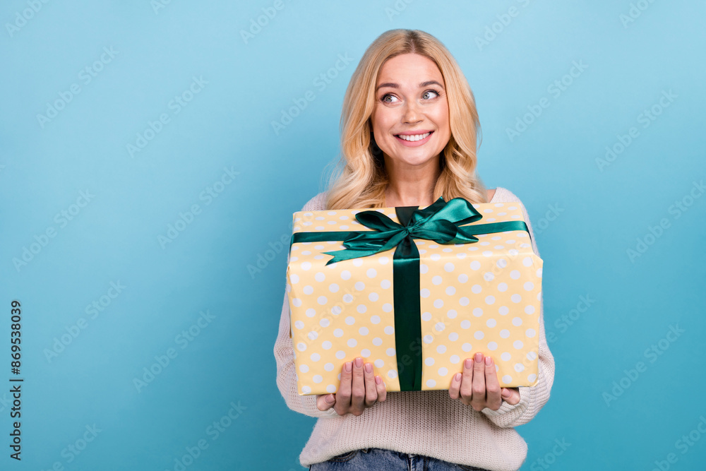 Photo of positive cheerful nice woman wear stylish white clothes look empty space isolated on blue color background Photo of positive cheerful nice woman wear stylish white clothes look empty space isolated on blue color background