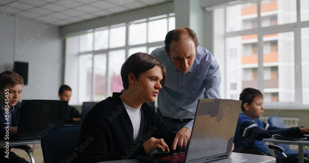Coding Classes In Modern School, Teacher And Student Teen Boy In Computer-Based Classroom Coding Classes In Modern School, Teacher And Student Teen Boy In Computer-Based Classroom
