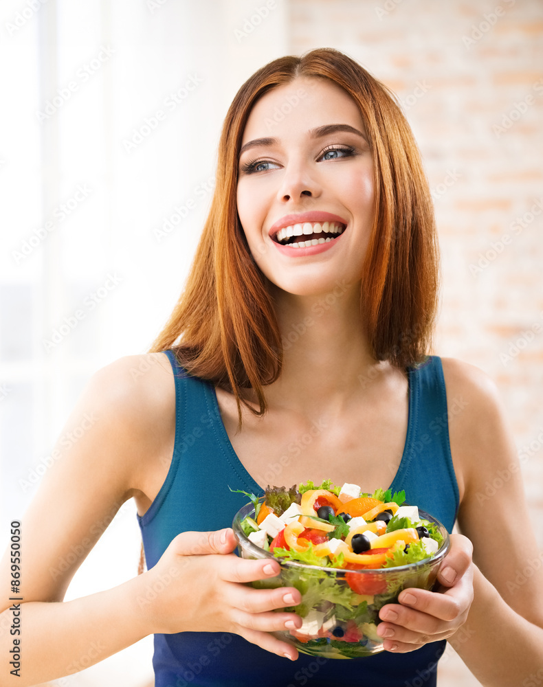 Portrait of happy amazed, smiling woman holding greece salad with cheese, indoor. Beautiful girl in casual blue dress - dieting, weight loss, healthy vegetarian eating concept. Portrait of happy amazed, smiling woman holding greece salad with cheese, indoor. Beautiful girl in casual blue dress - dieting, weight loss, healthy vegetarian eating concept.