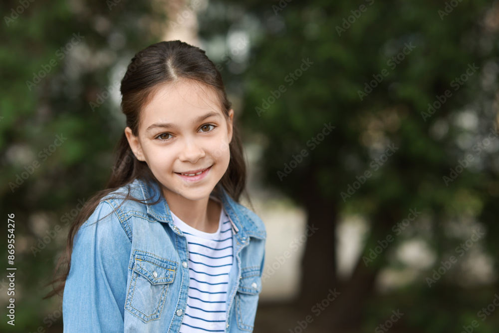 Portrait of happy little girl outdoors, space for text Portrait of happy little girl outdoors, space for text