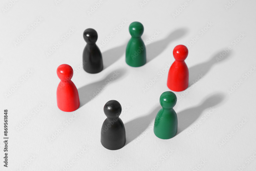 Equality concept. Different game pieces on light background Equality concept. Different game pieces on light background