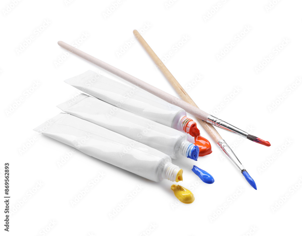 Tubes with colorful paints and brushes isolated on white Tubes with colorful paints and brushes isolated on white
