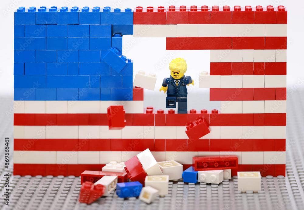 Obraz premium Hong Kong - July 1 2024: decent office man break the brick wall of usa flag