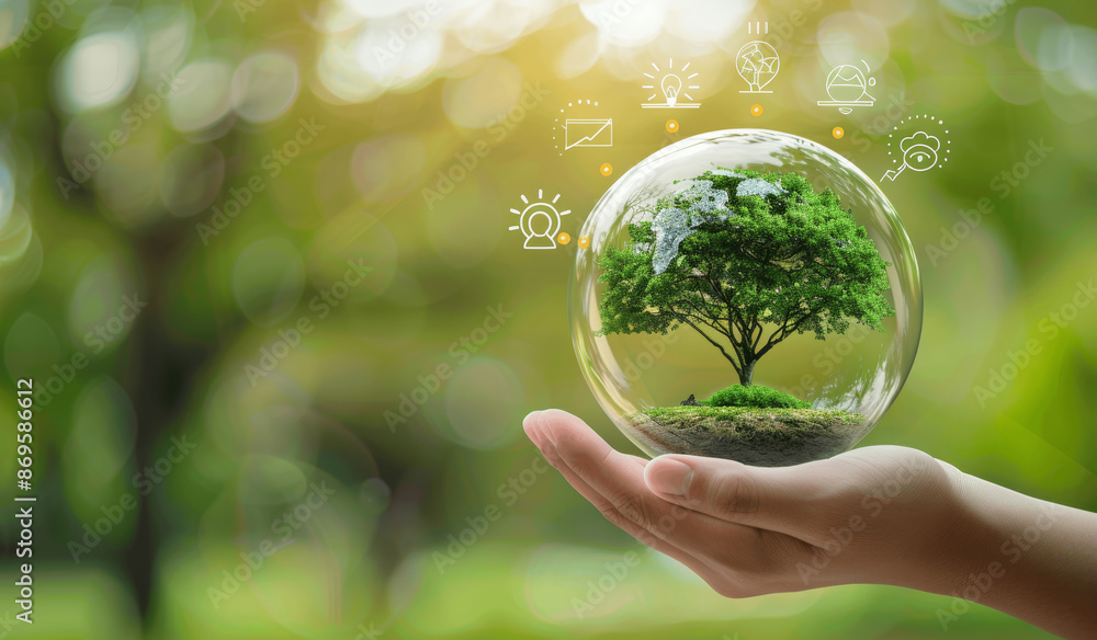 Hand Holding Tree in Glass Sphere with Energy and Environment Icons; Promoting Renewable Resources and Sustainable Living Hand Holding Tree in Glass Sphere with Energy and Environment Icons; Promoting Renewable Resources and Sustainable Living