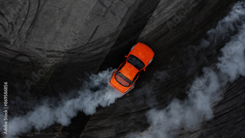 Obraz na płótnie Aerial top view car drifting diffusion race drift car with lots of smoke from burning tires on speed track, Professional driver drifting car with lots of white smoke. w salonie