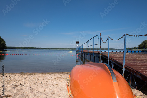 SWIMMING BEACH BY THE LAKE - Rowing water rescue boat on the sand
 photo