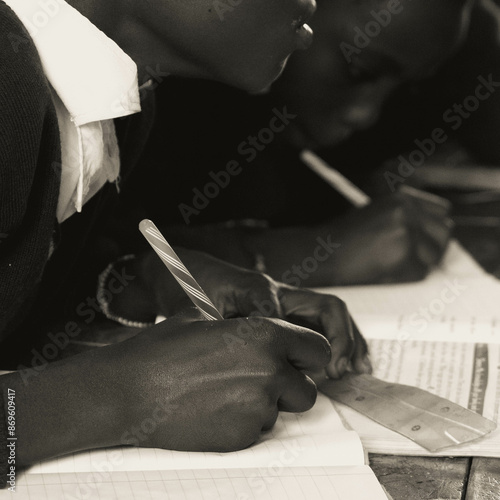 close up of an African child writing on a notebook