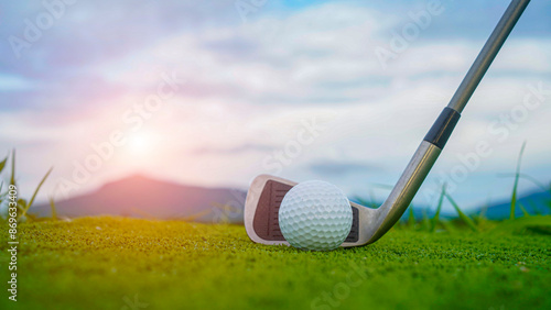 Golf ball and wooden driver on green grass background. photo