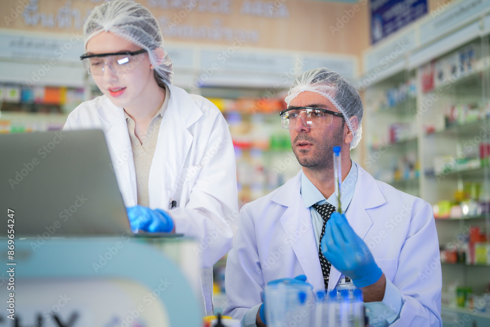 scientists perform experiments and record data. people arranges equipment with test tubes and chemicals for producing medicine and biochemistry. man hold tubes of chemical liquids and plant samples. scientists perform experiments and record data. people arranges equipment with test tubes and chemicals for producing medicine and biochemistry. man hold tubes of chemical liquids and plant samples.