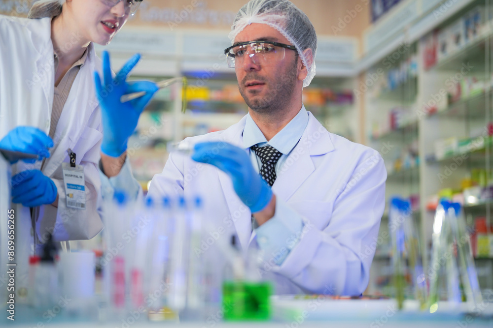 scientists perform experiments and record data. people arranges equipment with test tubes and chemicals for producing medicine and biochemistry. man hold tubes of chemical liquids and plant samples. scientists perform experiments and record data. people arranges equipment with test tubes and chemicals for producing medicine and biochemistry. man hold tubes of chemical liquids and plant samples.