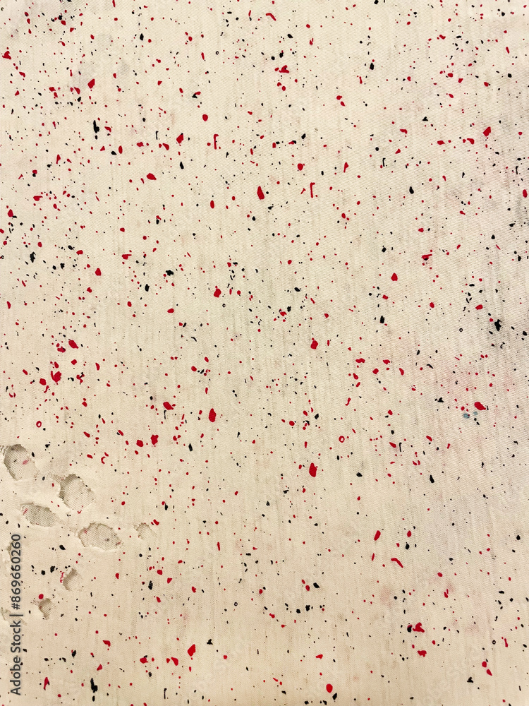Fabric with delicate paint splashes, close-up as texture. Old-fashioned cotton or linen textile in retro style with a print of scattered bright red splashes on a white background. Fabric with delicate paint splashes, close-up as texture. Old-fashioned cotton or linen textile in retro style with a print of scattered bright red splashes on a white background.