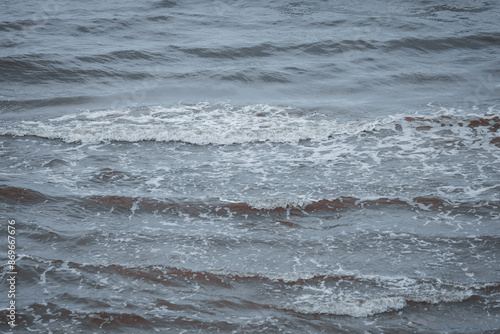 Upper seaside view with waves forming near costal line.