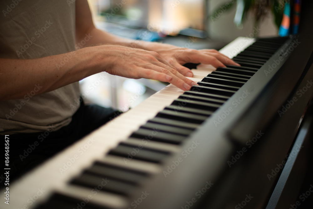 Obraz premium Close-up of Hands Playing an Electric Piano