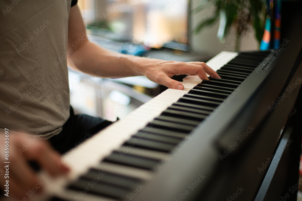 Obraz premium Close-up of Hands Playing an Electric Piano