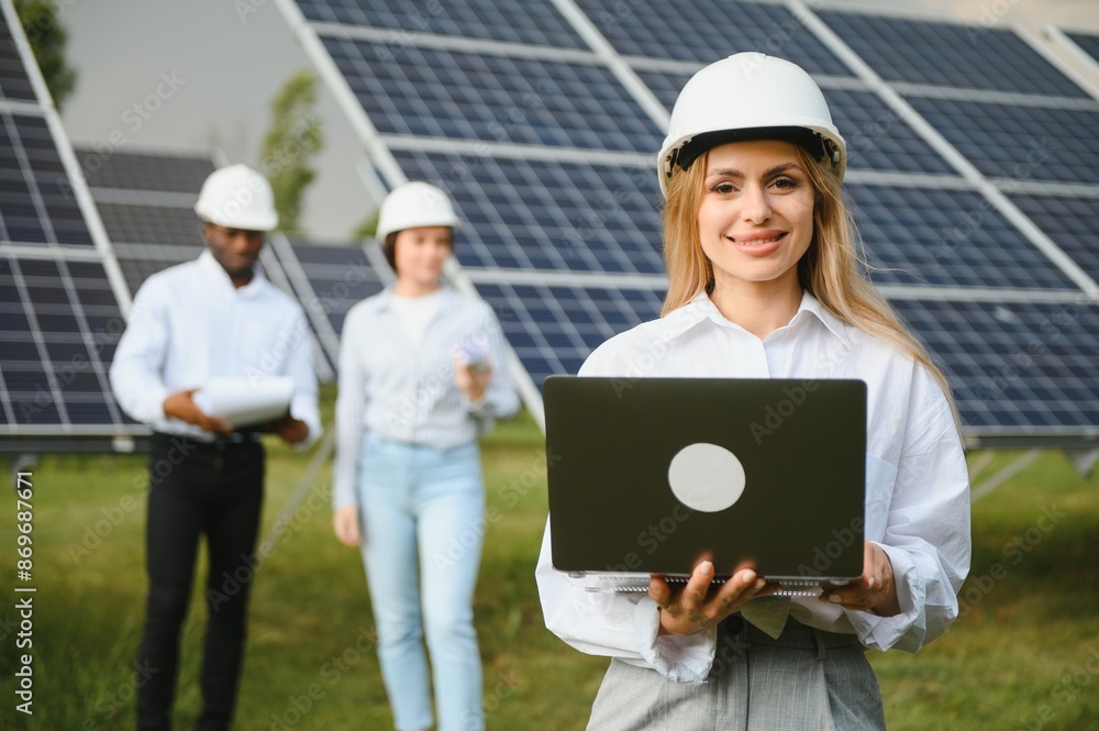 Group of investors together with young lady ecological engineer they analysing the plan of work and the efficient operation of solar batteries Group of investors together with young lady ecological engineer they analysing the plan of work and the efficient operation of solar batteries