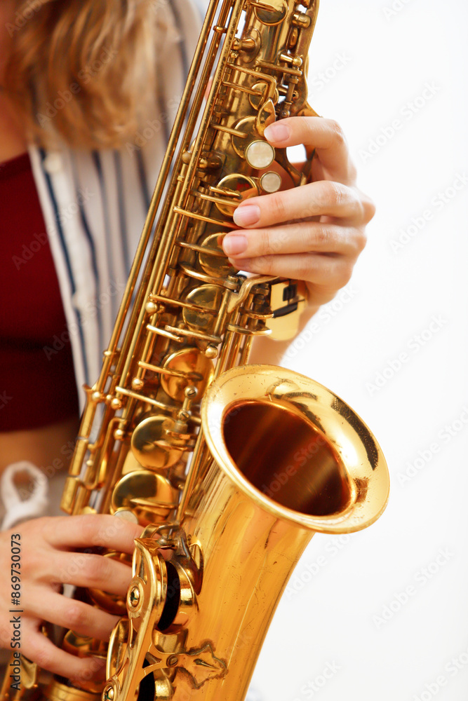 Fototapeta premium detail of woman's hands playing saxophone