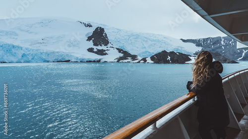 Antarctica Cruise Passenger Views Glacier. Beautiful Girl Hair Blowing in Wind on Side Railing Tour Excursion Landscape Nature Adventure Expedition