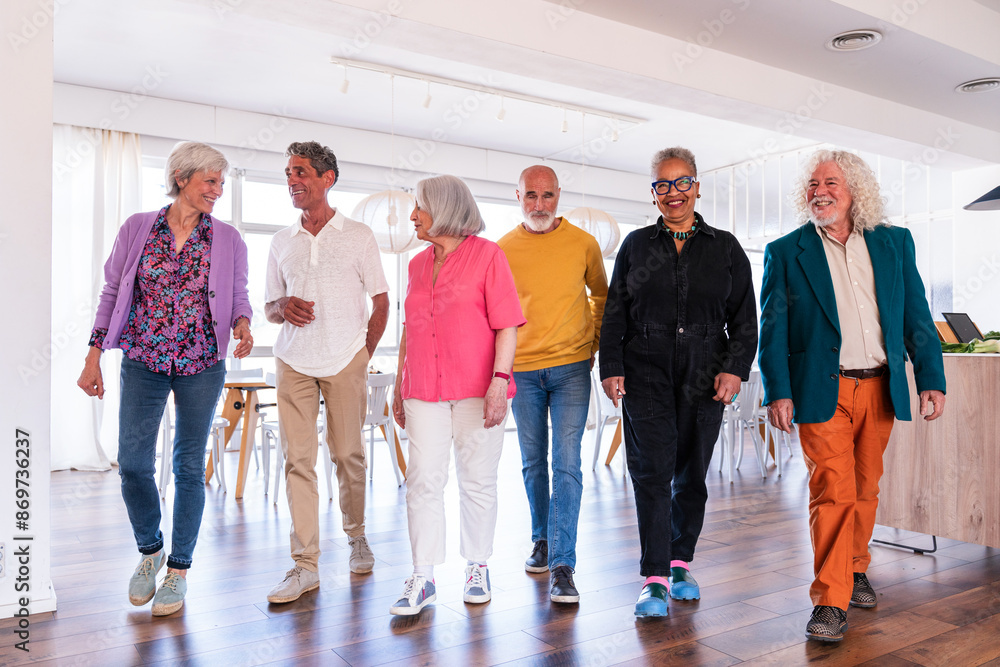 Group of happy senior friends bonding at home for dinner party - Cheerful and youthful old mature multiethnic people having fun Group of happy senior friends bonding at home for dinner party - Cheerful and youthful old mature multiethnic people having fun