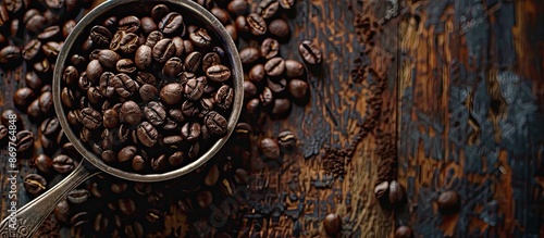 Coffee beans roasted with a spoon and saucer on a wooden backdrop, with copy space image available. photo