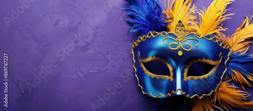 Colorful carnival mask featuring blue and yellow feathers on a purple background, perfect for Mardi Gras, Brazilian, and Venetian themes. Includes copy space image. photo