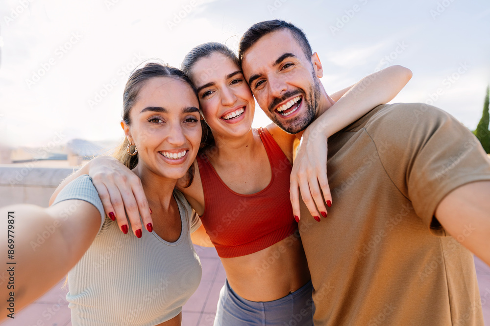 Three young sportive friends taking selfie after workout routine outdoor. Friendship, sport and healthy lifestyle concept Three young sportive friends taking selfie after workout routine outdoor. Friendship, sport and healthy lifestyle concept