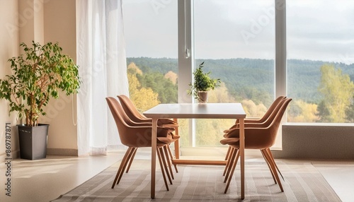 Stylish interior of apartment with table and chairs near window