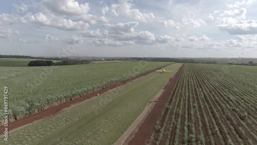 Agricultural plane taking off from plantation Drone 4k following from behind aerial photo