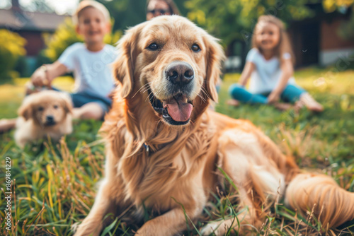 Joyful Family with Kids and Dog Enjoying Time Together in the Backyard Happy Couple Smiling at Camera as Golden Retriever Walks Away © Fernando Cortés