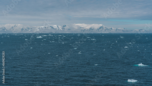 Beautiful Wide View of Antarctica Floating Icebergs Snow Covered Mountains Serene Nature Landscape Climate Change View From Cruise Ship