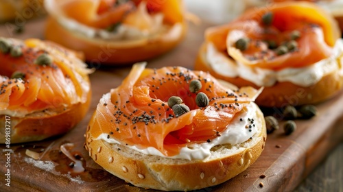 Toasted bagels topped with creamy spread thinly sliced smoked salmon and capers.