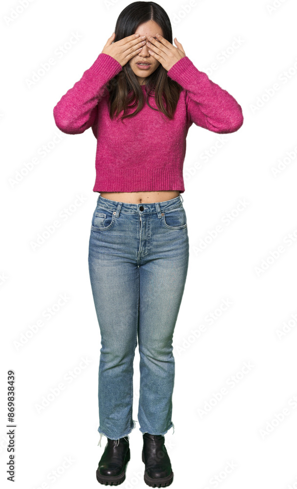 Full-body young Chinese woman afraid covering eyes with hands. Full-body young Chinese woman afraid covering eyes with hands.