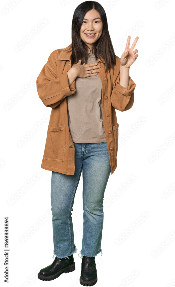 Full-body young Chinese woman taking an oath, putting hand on chest. Full-body young Chinese woman taking an oath, putting hand on chest.