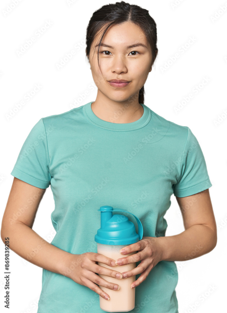 Chinese athlete with protein shake and jar in studio Chinese athlete with protein shake and jar in studio