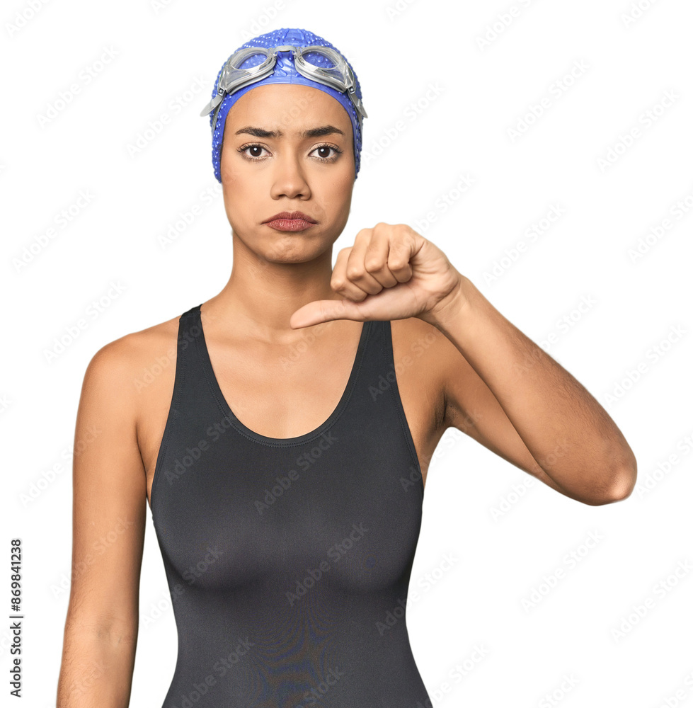 Pro Latina swimmer in studio gear showing a dislike gesture, thumbs down. Disagreement concept. Pro Latina swimmer in studio gear showing a dislike gesture, thumbs down. Disagreement concept.