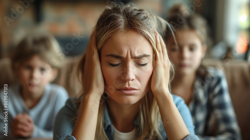 a woman has headache and stress because of children's problems , children on background .A mother suffers from headaches, tension and psychological pressure due to her children’s problems