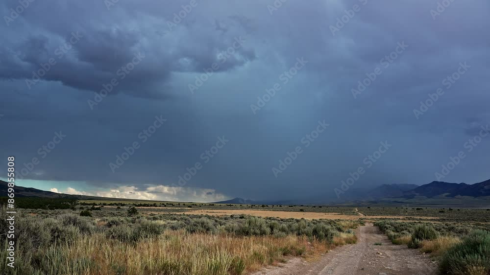 Lightning flashes in storm over the Utah desert looking down dirt road leading to the bad weather. Lightning flashes in storm over the Utah desert looking down dirt road leading to the bad weather.